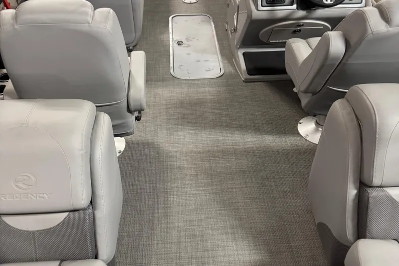 Slide: The Image of 2024 Regency 230 DL3 interior with gray seating and textured flooring. - 17