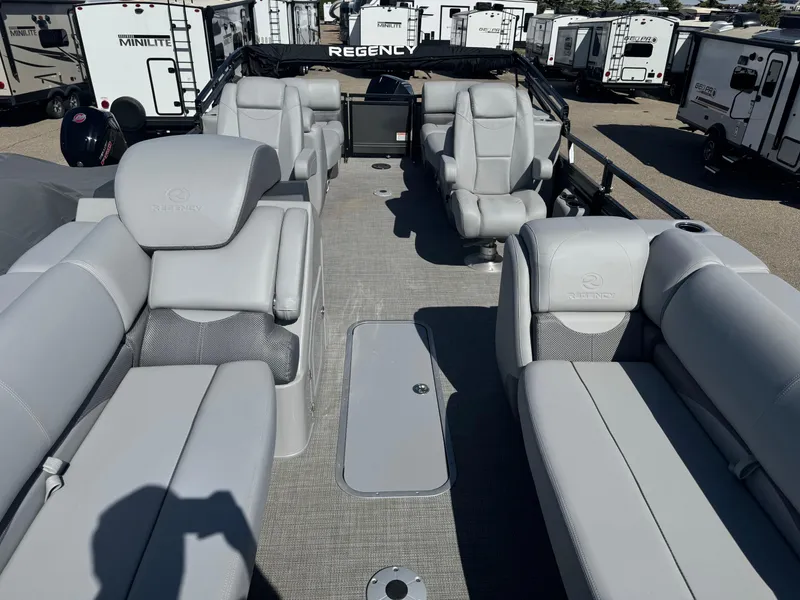 Slide: The Image of 2024 Regency 230 DL3 boat interior with plush white seating and modern design. - 6