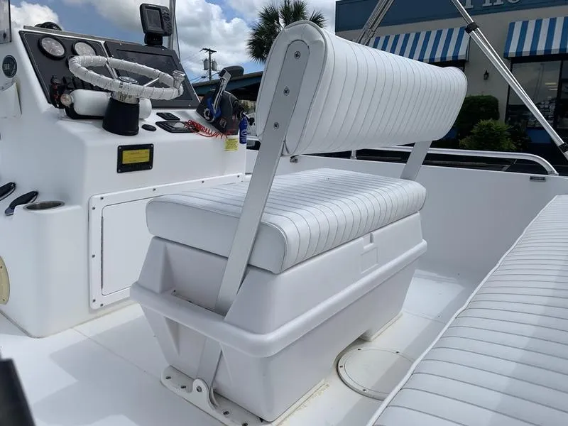 Slide: The Image of 2009 Sea King 198 Bay boat interior with white cushioned seating and control panel. - 10