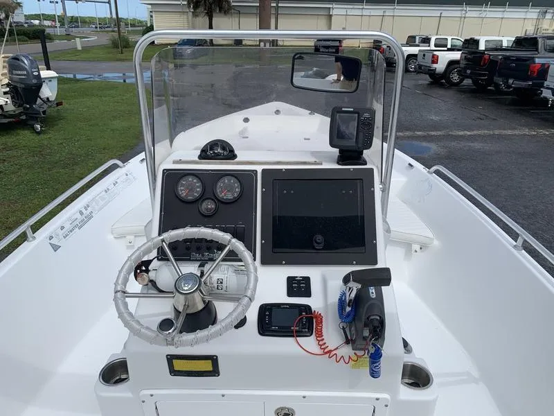 Slide: The Image of 2009 Sea King 198 Bay boat dashboard with steering wheel and navigation instruments. - 12