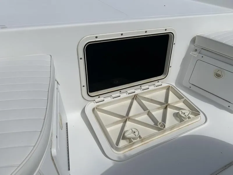 Slide: The Image of 2009 Sea King 198 Bay boat storage compartment with open hatch, showcasing interior design. - 18