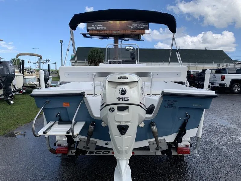 Slide: The Image of 2009 Sea King 198 Bay boat with 115 HP outboard motor, parked outdoors. - 3
