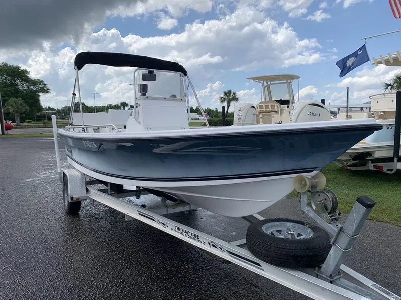 Slide: The Image of 2009 Sea King 198 Bay boat on trailer under cloudy sky. - 6