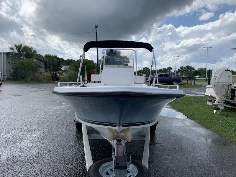 Slide: The Image of 2009 Sea King 198 Bay boat on trailer, parked outdoors under cloudy sky. - 7