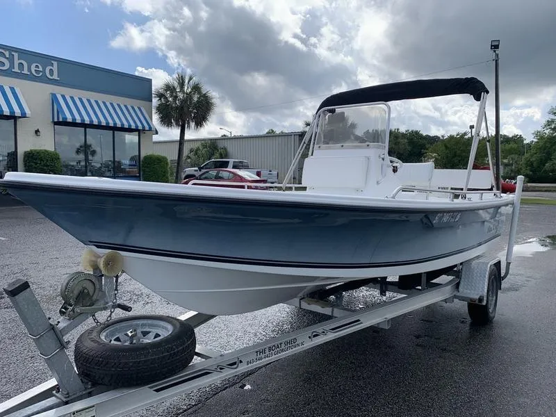 Slide: The Image of 2009 Sea King 198 Bay boat on trailer, parked outside a store with striped awnings. - 8