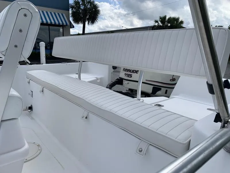 Slide: The Image of 2009 Sea King 198 Bay boat interior with white seating and Evinrude 115 engine. - 9