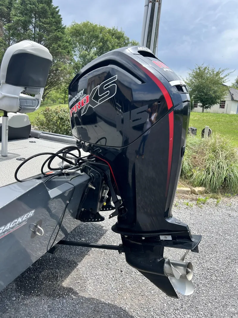 Slide: The Image of 2018 Tracker Pro Team 195 TXW boat with powerful outboard motor, parked on gravel. - 3