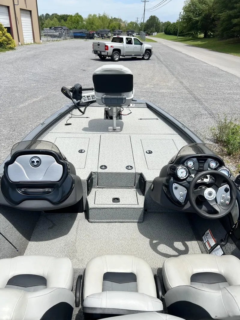 Slide: The Image of 2018 Tracker Pro Team 195 TXW fishing boat interior with steering console and seating. - 4