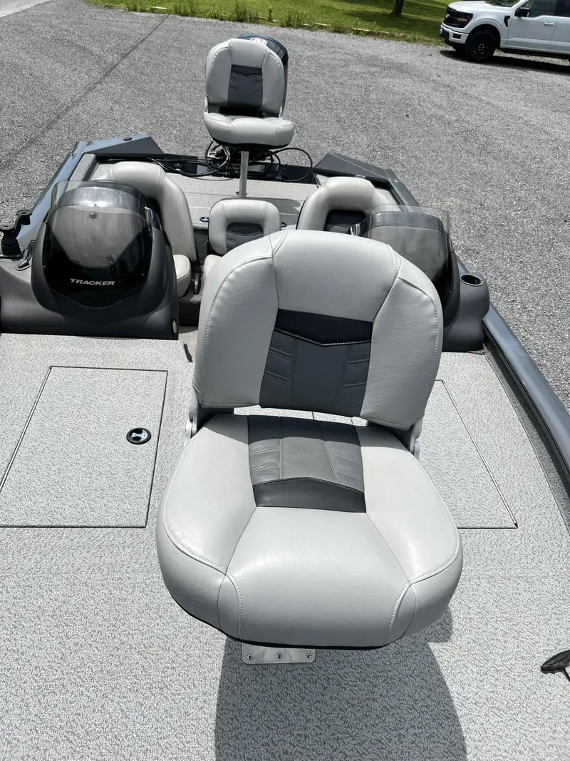 Slide: The Image of 2018 Tracker Pro Team 195 TXW boat with gray seating and console, parked on gravel. - 6