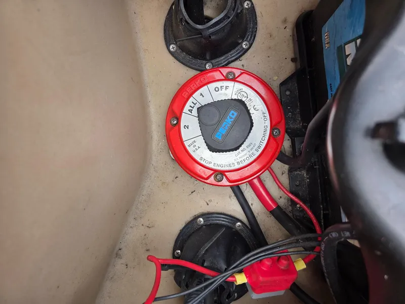 Slide: The Image of Battery switch in a 2011 Bennington 2554GCW boat, showing wiring and connections. - 13