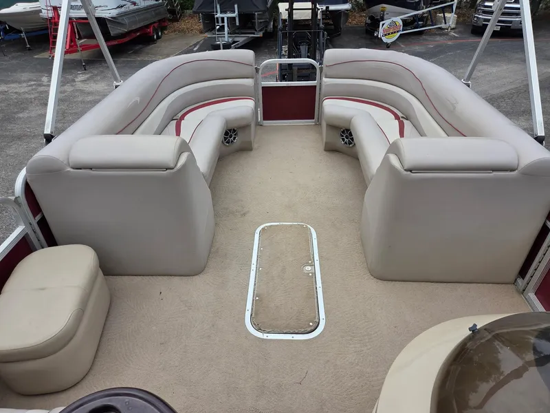 Slide: The Image of 2011 Bennington 2554GCW pontoon boat interior with beige seating and carpet. - 3