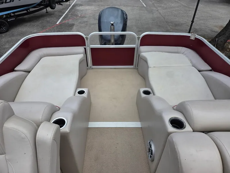 Slide: The Image of 2011 Bennington 2554GCW pontoon boat interior with beige seating and cup holders. - 8