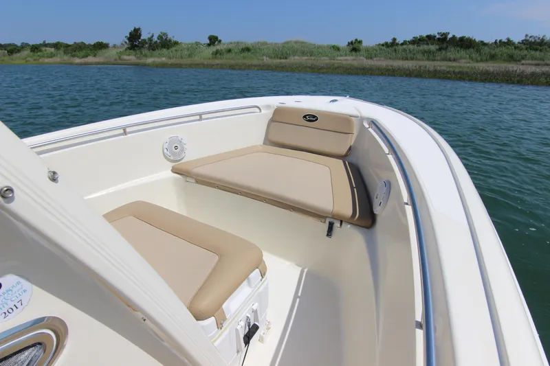 Slide: The Image of 2011 Scout 222 Sportfish boat with beige seating on calm water. - 11