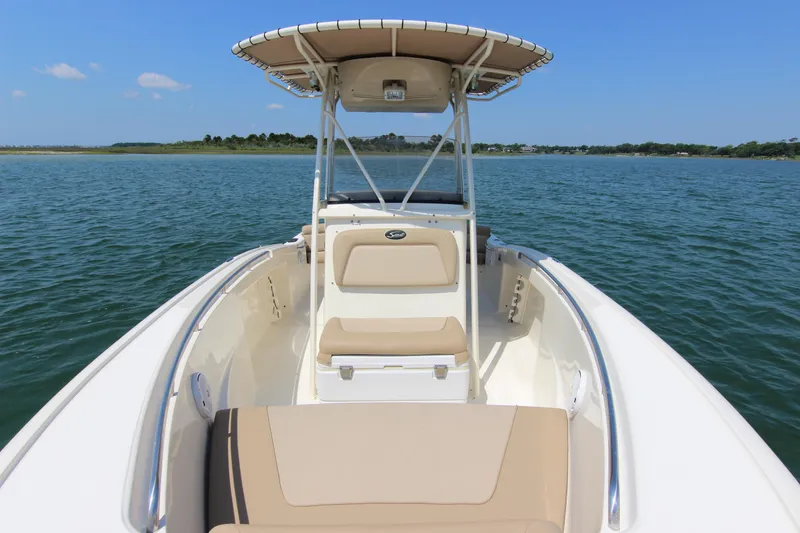 Slide: The Image of 2011 Scout 222 Sportfish boat on calm water, featuring a sleek design and spacious seating. - 14