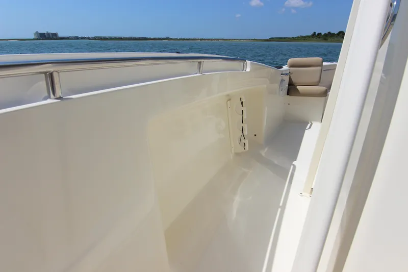 Slide: The Image of 2011 Scout 222 Sportfish boat deck with seating, on calm water. - 16