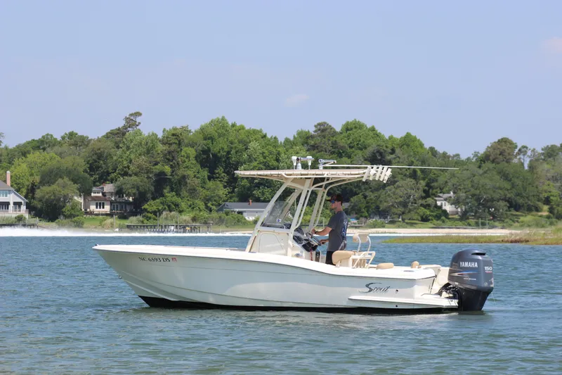 Slide: The Image of 2011 Scout 222 Sportfish boat on water with Yamaha outboard, scenic background. - 2