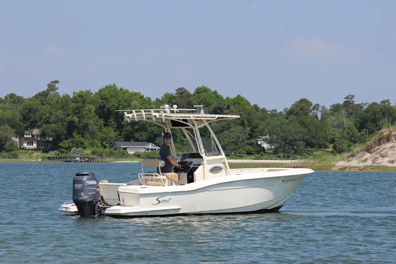 Slide: The Image of 2011 Scout 222 Sportfish boat on calm water with scenic background. - 5