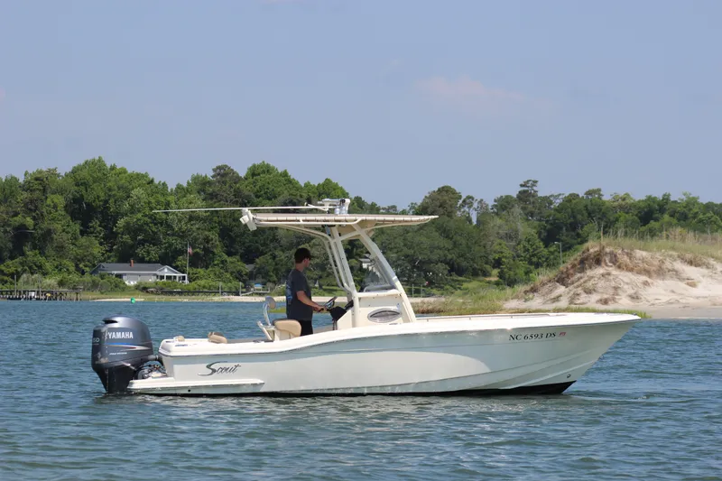 Slide: The Image of 2011 Scout 222 Sportfish boat on water with Yamaha outboard, near shoreline and trees. - 7