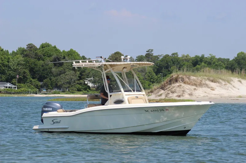 Slide: The Image of 2011 Scout 222 Sportfish boat on water near sandy shoreline. - 8