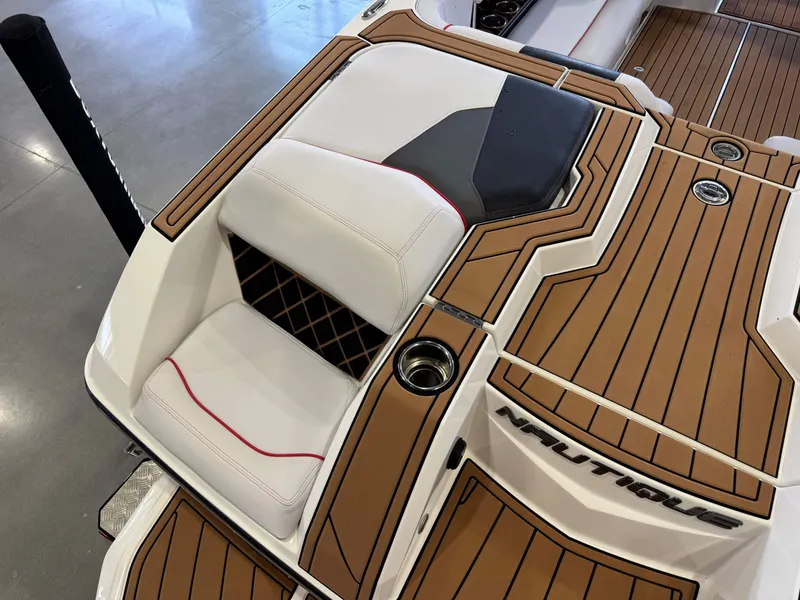 Slide: The Image of 2019 Nautique Super Air Nautique GS22 boat interior with teak flooring and white seating. - 12