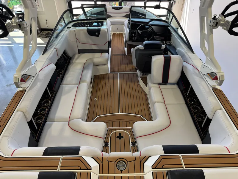 Slide: The Image of 2019 Nautique Super Air Nautique GS22 interior with white seating and wood accents. - 13
