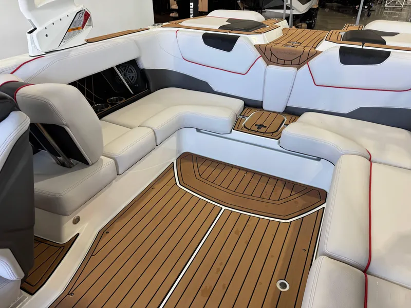 Slide: The Image of 2019 Nautique Super Air Nautique GS22 interior with white seating and teak flooring. - 16