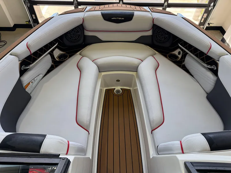 Slide: The Image of 2019 Nautique Super Air Nautique GS22 interior with white seating and red accents. - 18