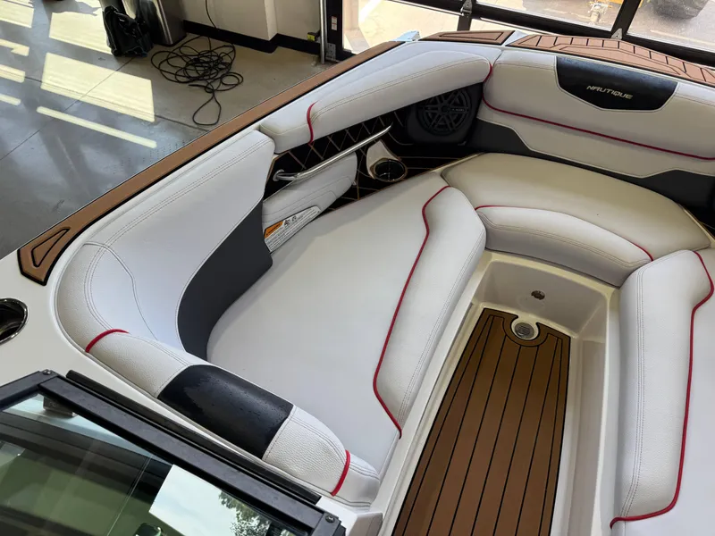 Slide: The Image of 2019 Nautique Super Air Nautique GS22 interior with white seating and wood accents. - 20