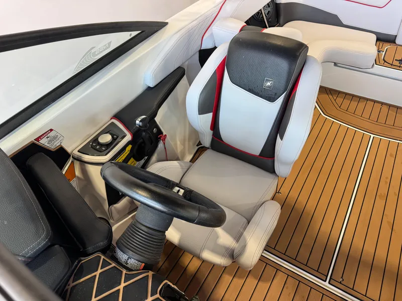 Slide: The Image of 2019 Nautique Super Air Nautique GS22 cockpit with modern steering and seating. - 22