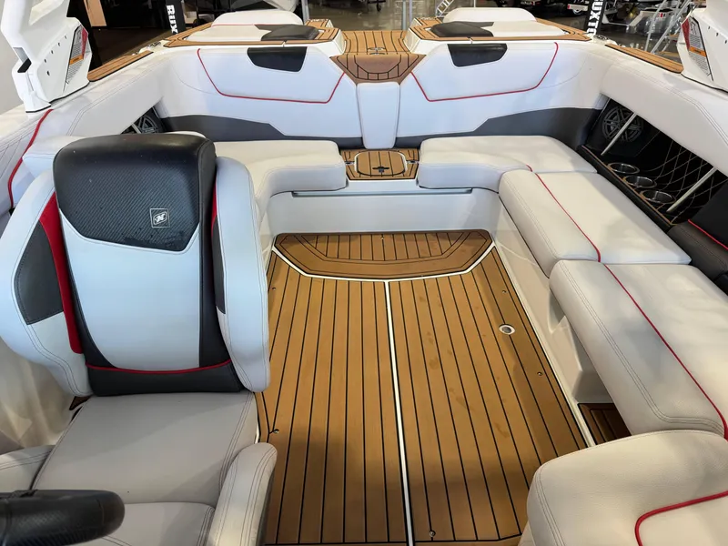 Slide: The Image of 2019 Nautique Super Air Nautique GS22 interior with luxurious seating and teak flooring. - 23