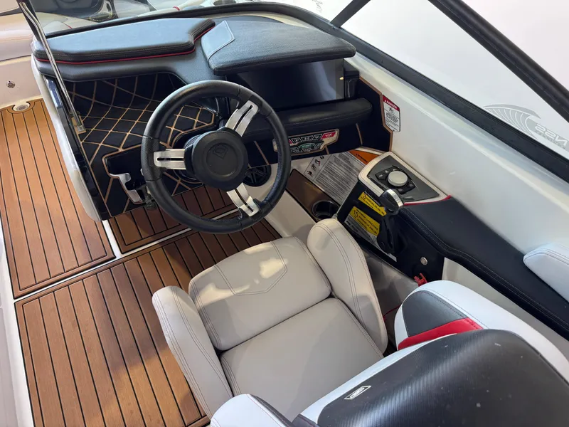 Slide: The Image of 2019 Nautique Super Air Nautique GS22 cockpit with sleek steering wheel and modern controls. - 26