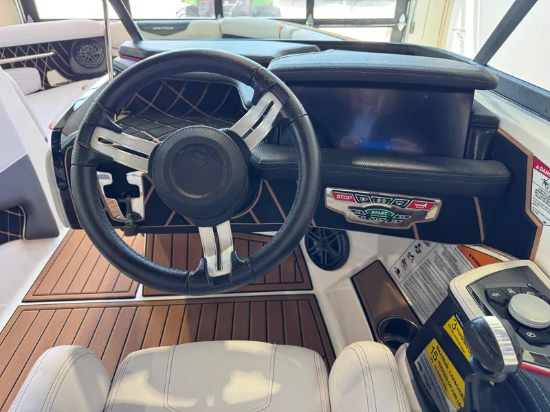 Slide: The Image of 2019 Nautique Super Air Nautique GS22 dashboard with steering wheel and control panel. - 27