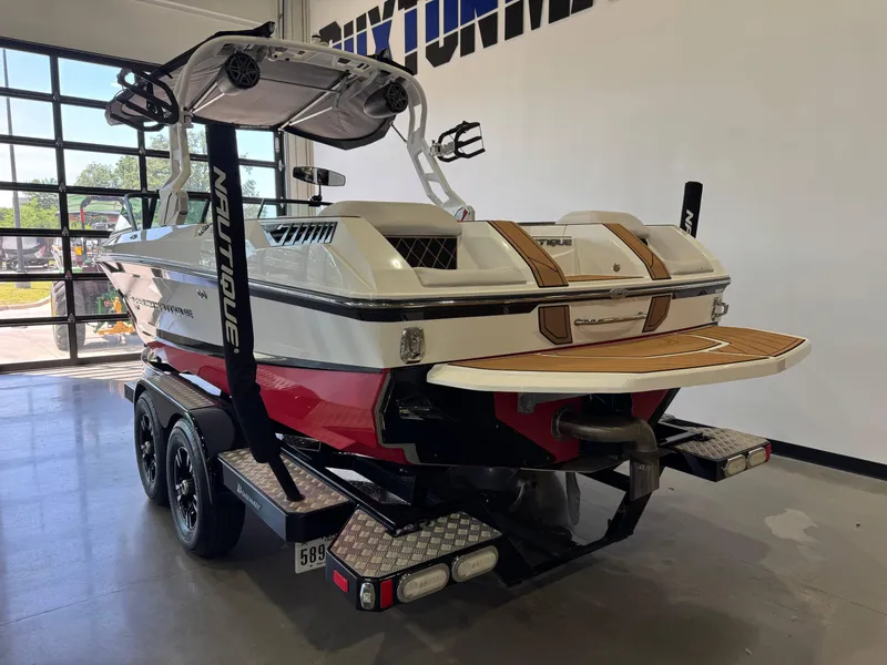 Slide: The Image of 2019 Nautique Super Air Nautique GS22 boat on trailer in showroom. - 5