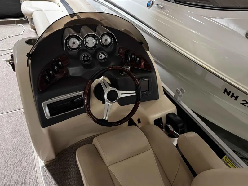 Slide: The Image of Steering console of 2011 Godfrey Aqua Patio 240 boat with gauges and controls. - 6