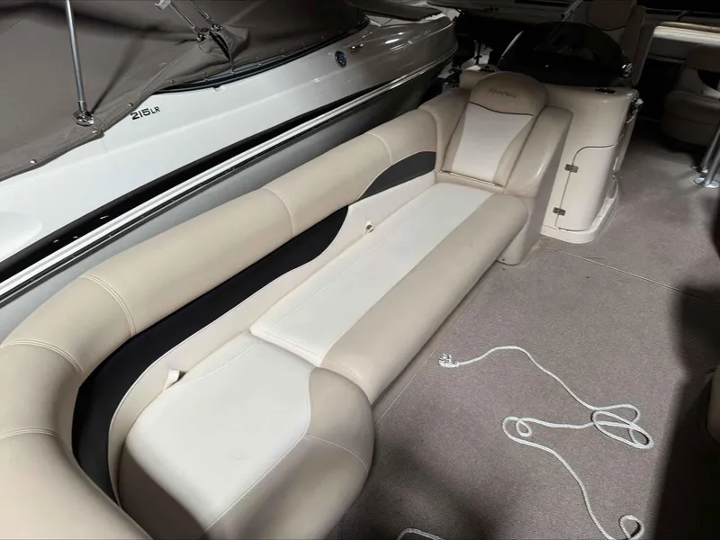 Slide: The Image of 2011 Godfrey Aqua Patio 240 boat interior with beige seating and carpeted floor. - 8