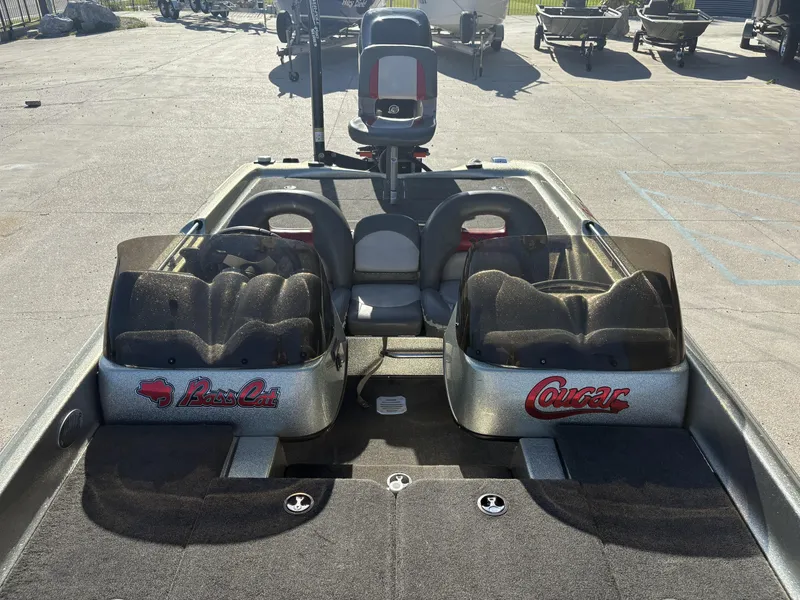 Slide: The Image of 2005 Bass Cat Cougar FTD boat interior with dual seats and branded consoles. - 4