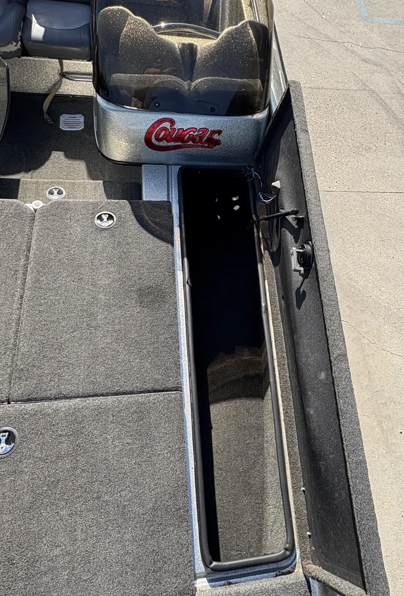 Slide: The Image of 2005 Bass Cat Cougar FTD boat interior with open storage compartment. - 5