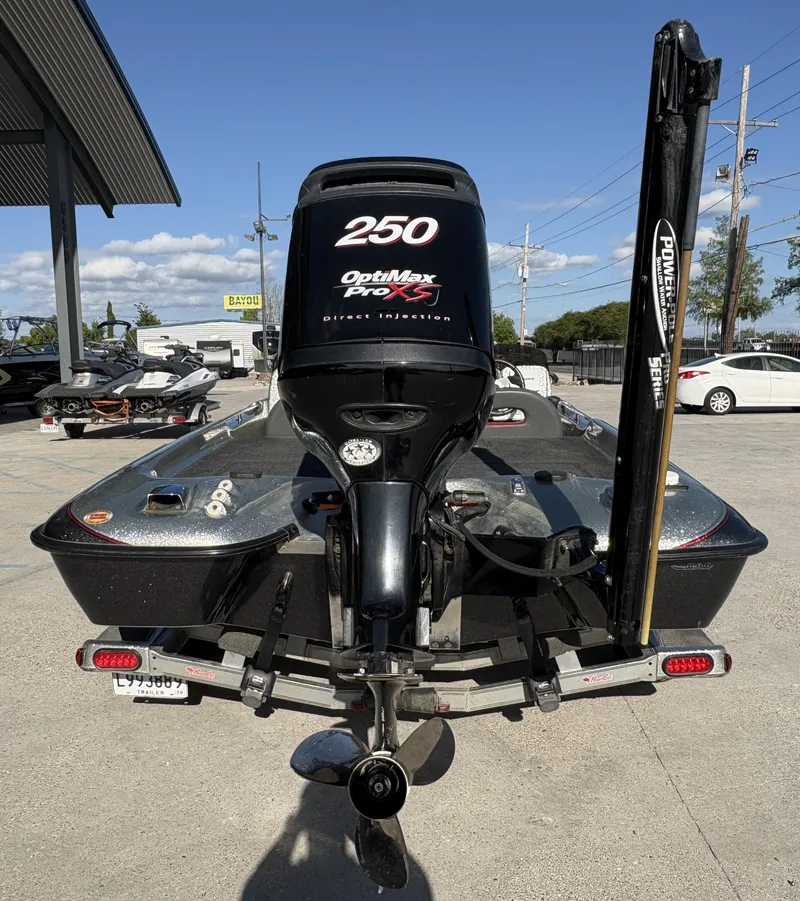 Slide: The Image of 2005 Bass Cat Cougar FTD boat with OptiMax Pro XS engine, parked outdoors. - 6