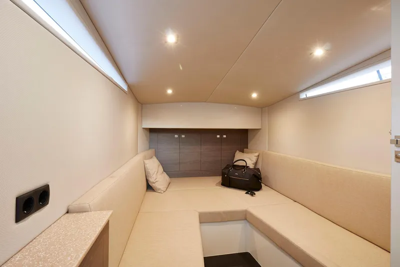 Slide: The Image of Interior of 2019 Chaser 500R boat, featuring beige seating and modern lighting. - 8