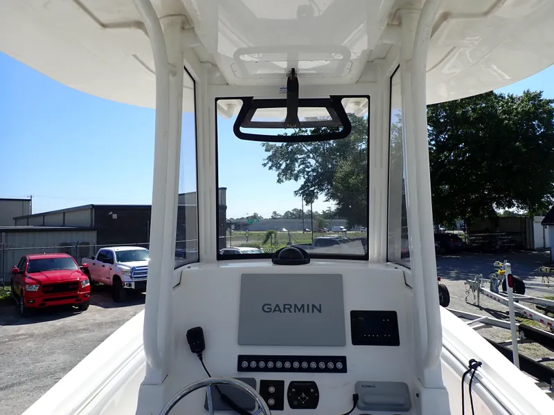 Slide: The Image of 2020 Regulator 23 boat cockpit with Garmin navigation system, parked outdoors. - 11