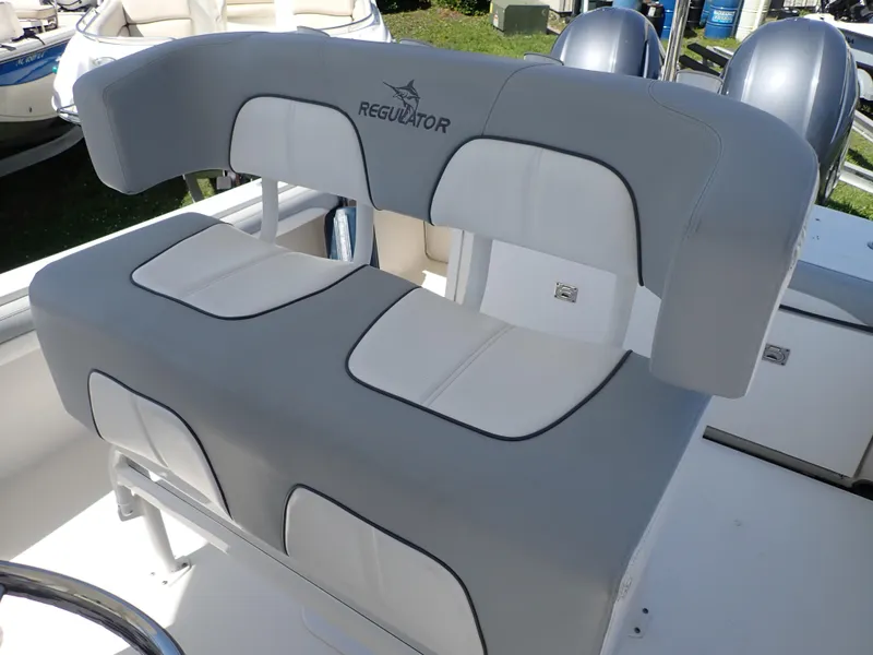 Slide: The Image of 2020 Regulator 23 boat seating with gray and white cushioned design. - 12