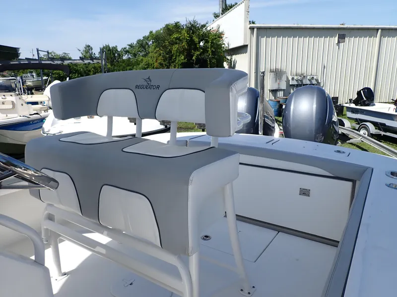 Slide: The Image of 2020 Regulator 23 boat interior with dual engines and cushioned seating. - 13