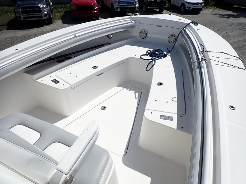 Slide: The Image of 2020 Regulator 23 boat interior with white seating and storage compartments. - 18