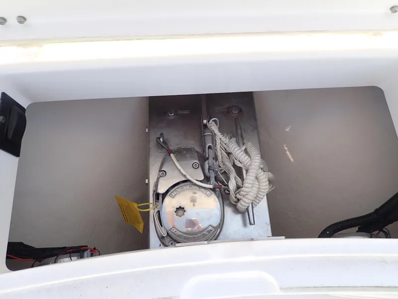 Slide: The Image of Anchor storage compartment on a 2020 Regulator 23 boat, featuring rope and winch. - 19