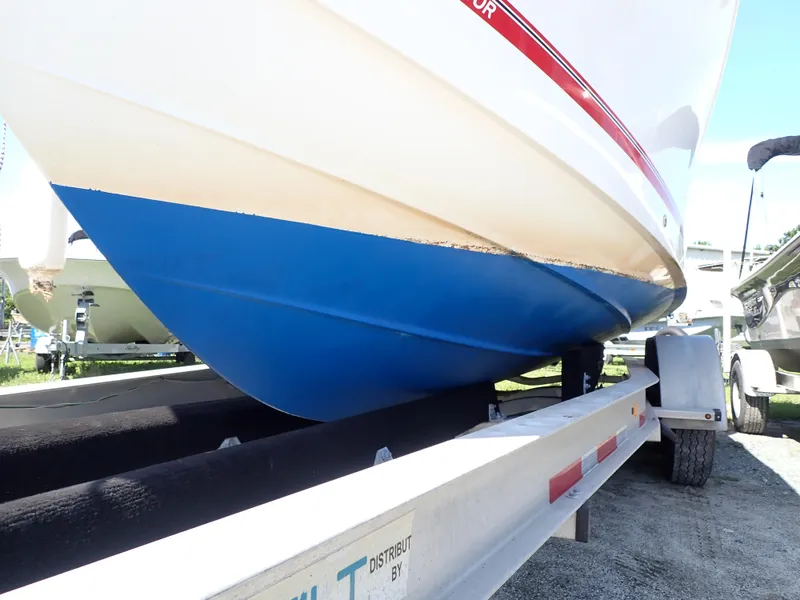 Slide: The Image of 2020 Regulator 23 boat on trailer, blue hull, side view. - 21