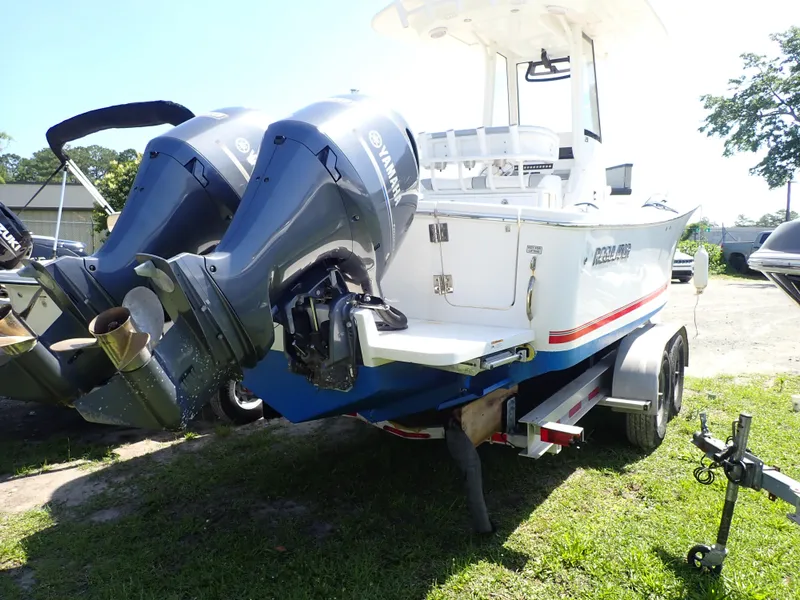 Slide: The Image of 2020 Regulator 23 boat with dual outboard engines on a trailer. - 22