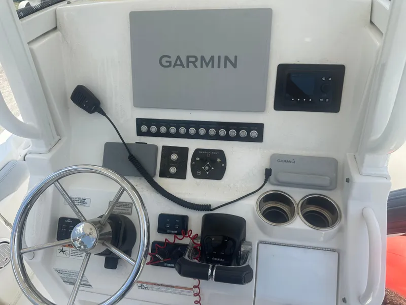 Slide: The Image of Control panel of 2020 Regulator 23 boat with Garmin navigation system and steering wheel. - 5