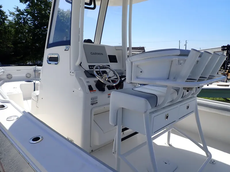 Slide: The Image of 2020 Regulator 23 boat cockpit with Garmin navigation system and seating. - 7