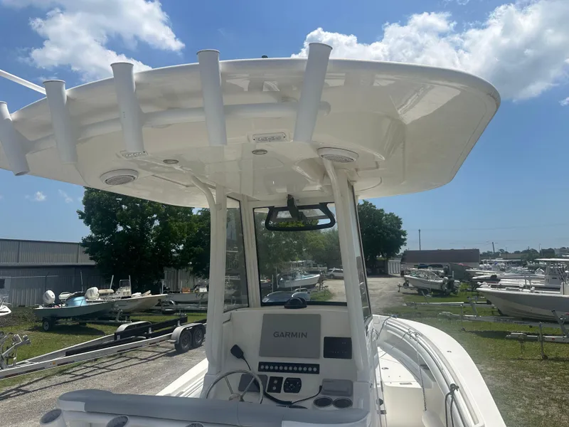Slide: The Image of 2020 Regulator 23 boat with Garmin electronics, docked under a clear blue sky. - 8