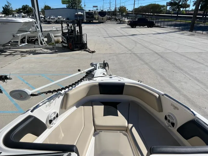 Slide: The Image of 2017 Chaparral H20 boat interior at a marina, showcasing seating and speakers. - 13